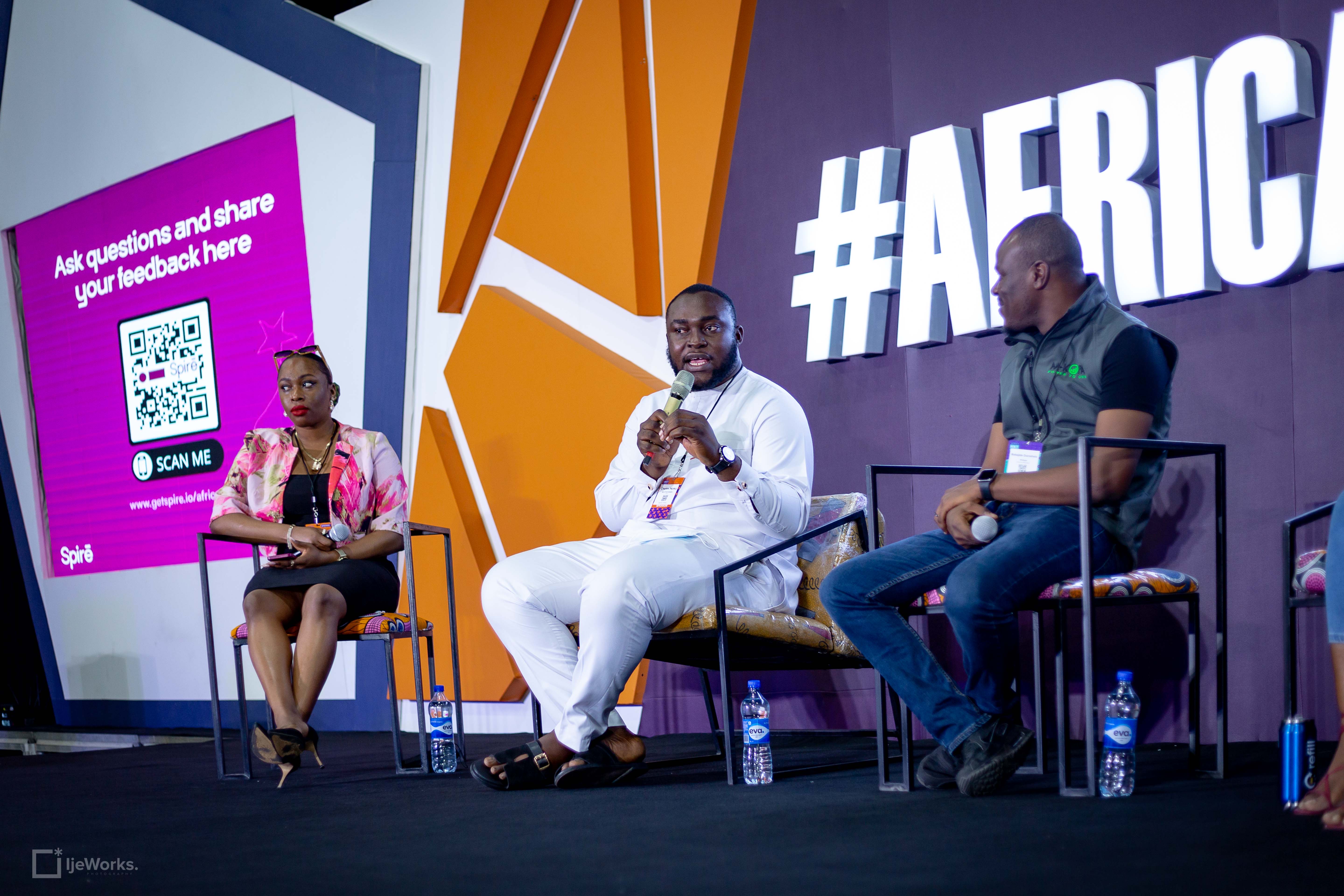 Image of Charles Njoku holding a mic and speaking